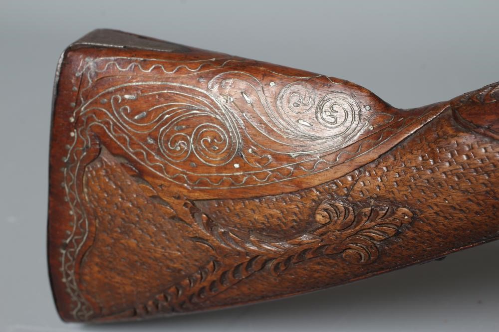 A FLINTLOCK BLUNDERBUSS PISTOL with 12" white metal inlaid barrel, carved and inlaid wood stock and Image