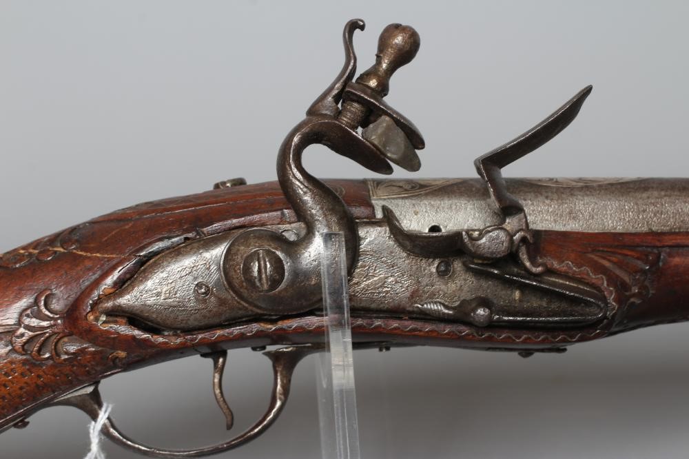 A FLINTLOCK BLUNDERBUSS PISTOL with 12" white metal inlaid barrel, carved and inlaid wood stock and Image