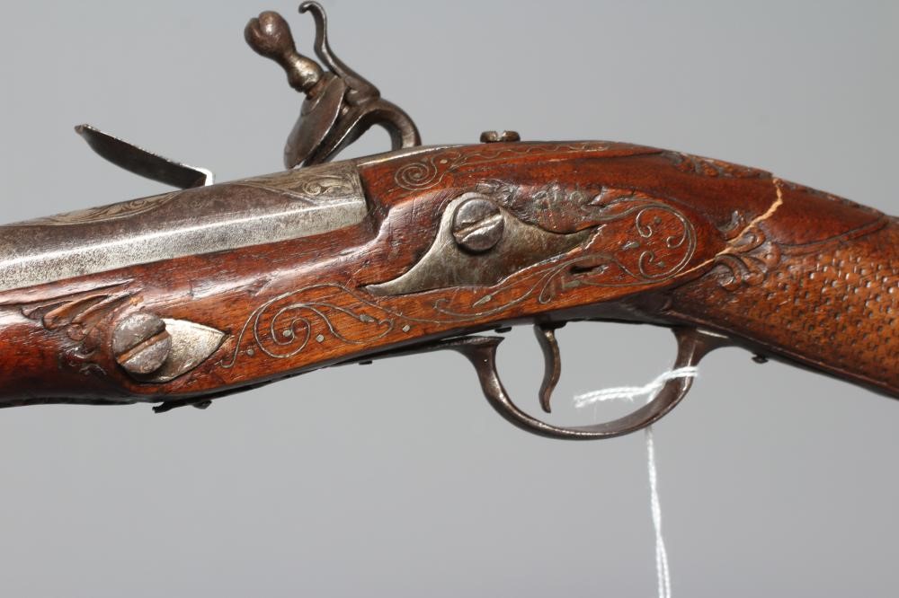 A FLINTLOCK BLUNDERBUSS PISTOL with 12" white metal inlaid barrel, carved and inlaid wood stock and Image
