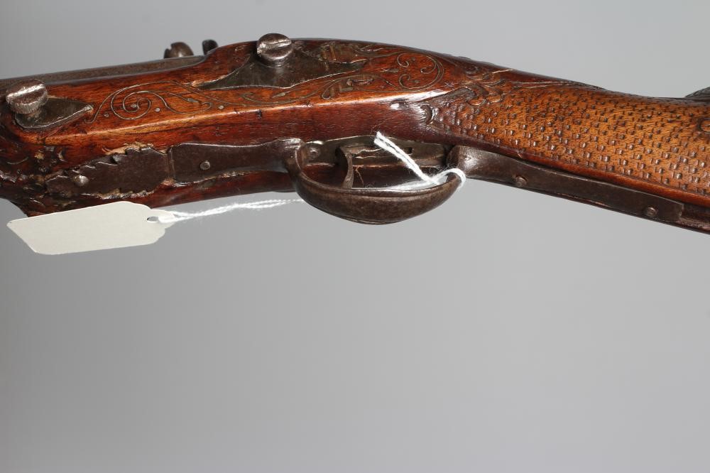 A FLINTLOCK BLUNDERBUSS PISTOL with 12" white metal inlaid barrel, carved and inlaid wood stock and Image