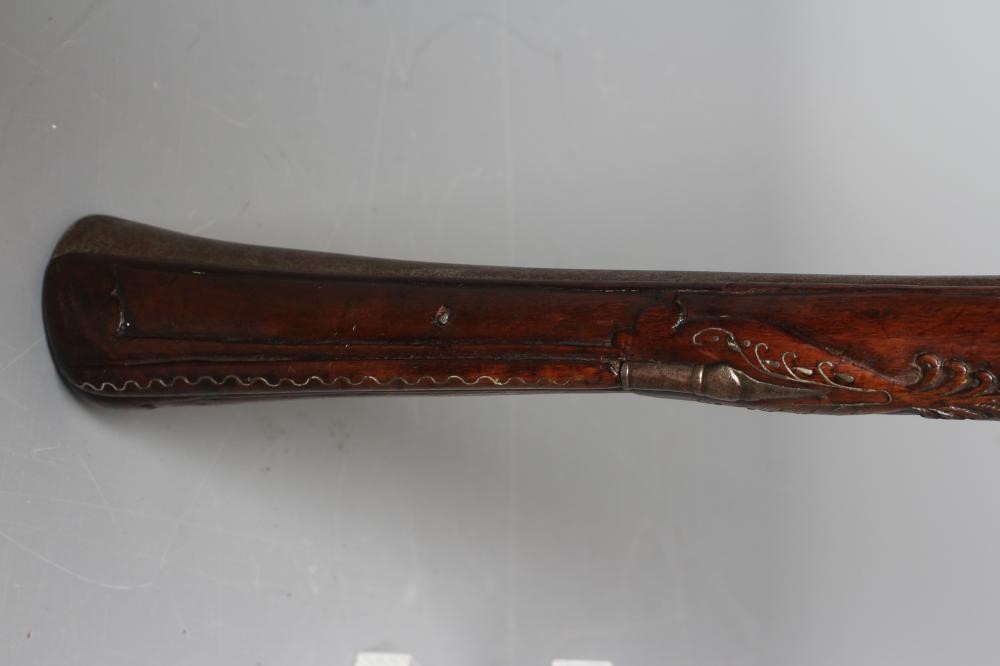 A FLINTLOCK BLUNDERBUSS PISTOL with 12" white metal inlaid barrel, carved and inlaid wood stock and Image