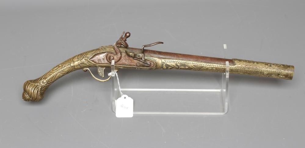 A FLINTLOCK PISTOL with 12" barrel, plain action and highly decorative foliate designed brass stock, Image