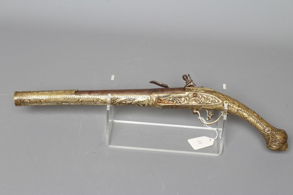 A FLINTLOCK PISTOL with 12" barrel, plain action and highly decorative foliate designed brass stock, Image
