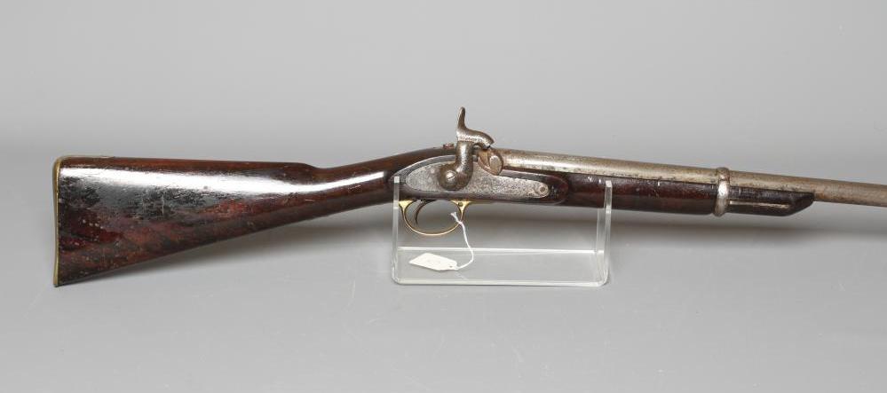 A PERCUSSION CARBINE MUSKET with 31" barrel, action bearing a crown, half length wood stock, brass Image