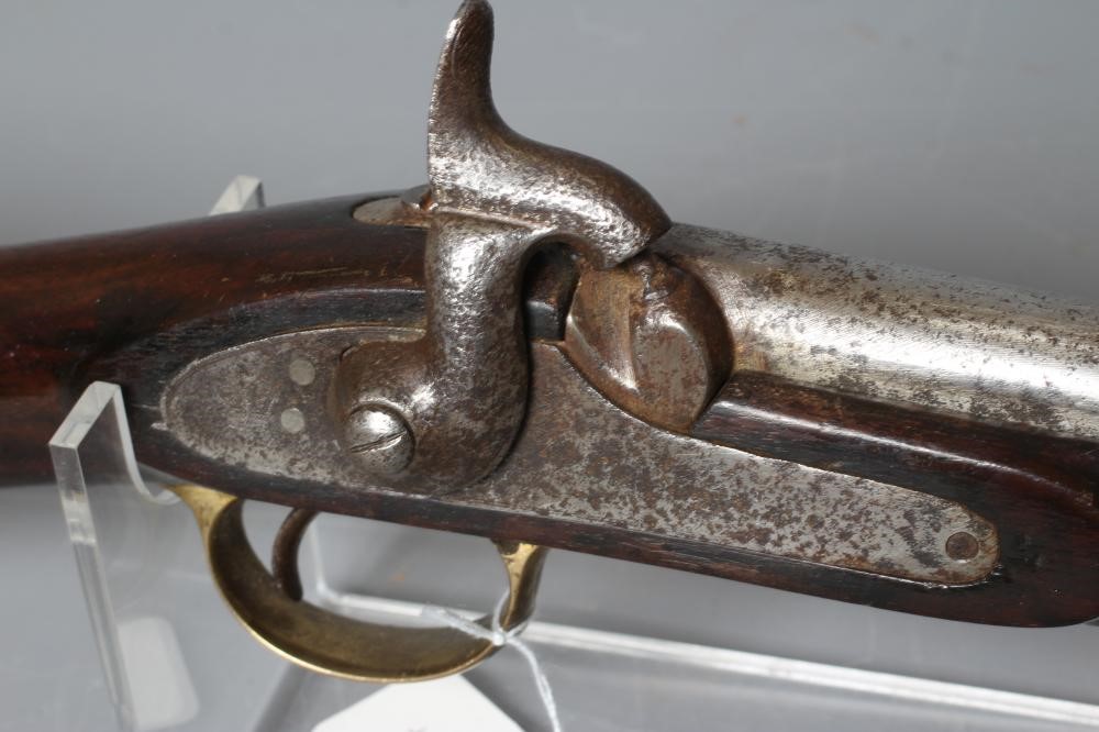 A PERCUSSION CARBINE MUSKET with 31" barrel, action bearing a crown, half length wood stock, brass Image