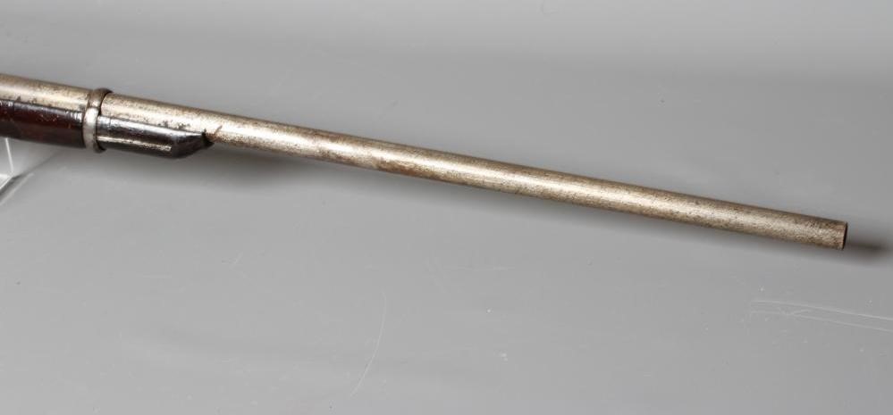 A PERCUSSION CARBINE MUSKET with 31" barrel, action bearing a crown, half length wood stock, brass Image