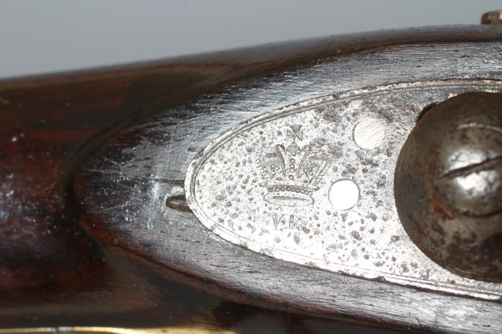 A PERCUSSION CARBINE MUSKET with 31" barrel, action bearing a crown, half length wood stock, brass Image