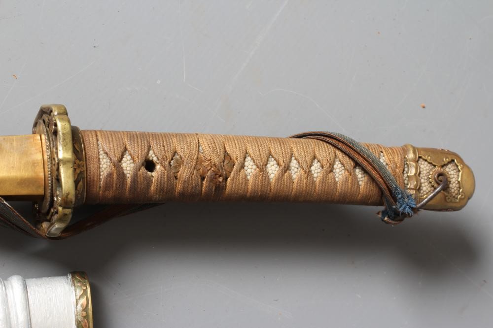 A JAPANESE KATANA with 26 1/4" curved blade, visible hamon, tang signed to both sides, WWII tsuba, Image
