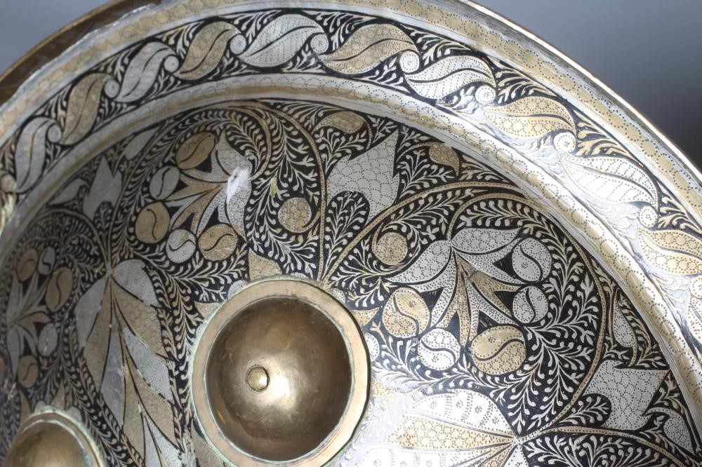 AN INDIAN CIRCULAR DHAL SHIELD with yellow and white metal niello decoration, four central bosses Image