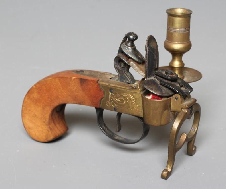 A FLINTLOCK TINDER LIGHTER, early 20th century, with candle holder, brass foliate etched action, Image