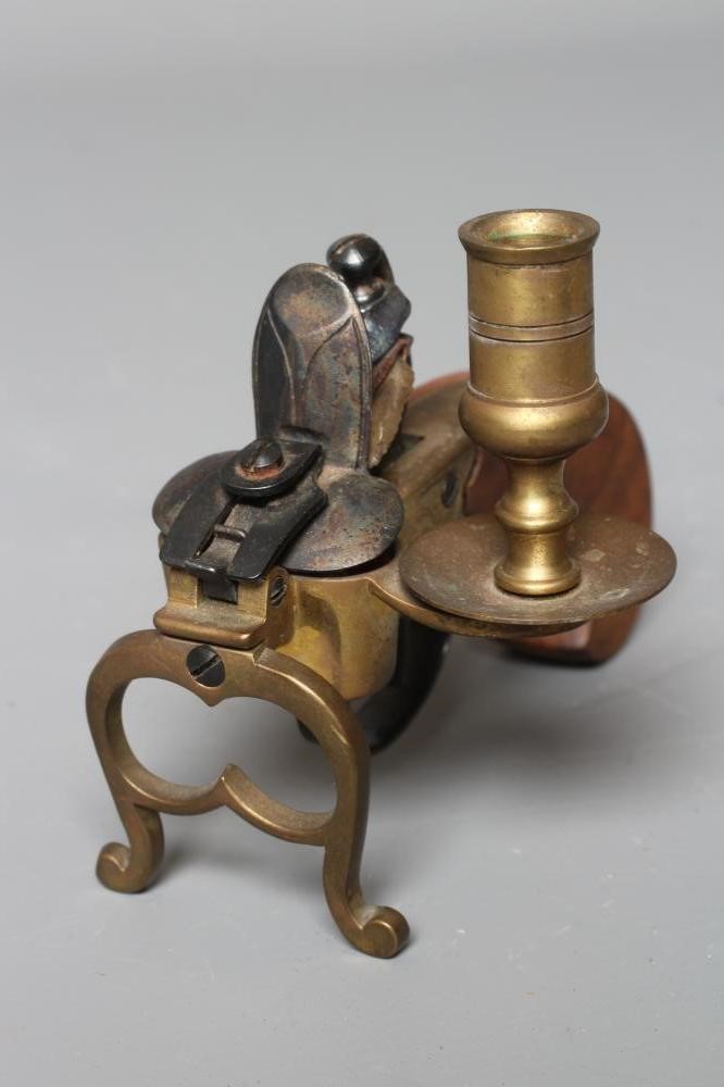 A FLINTLOCK TINDER LIGHTER, early 20th century, with candle holder, brass foliate etched action, Image