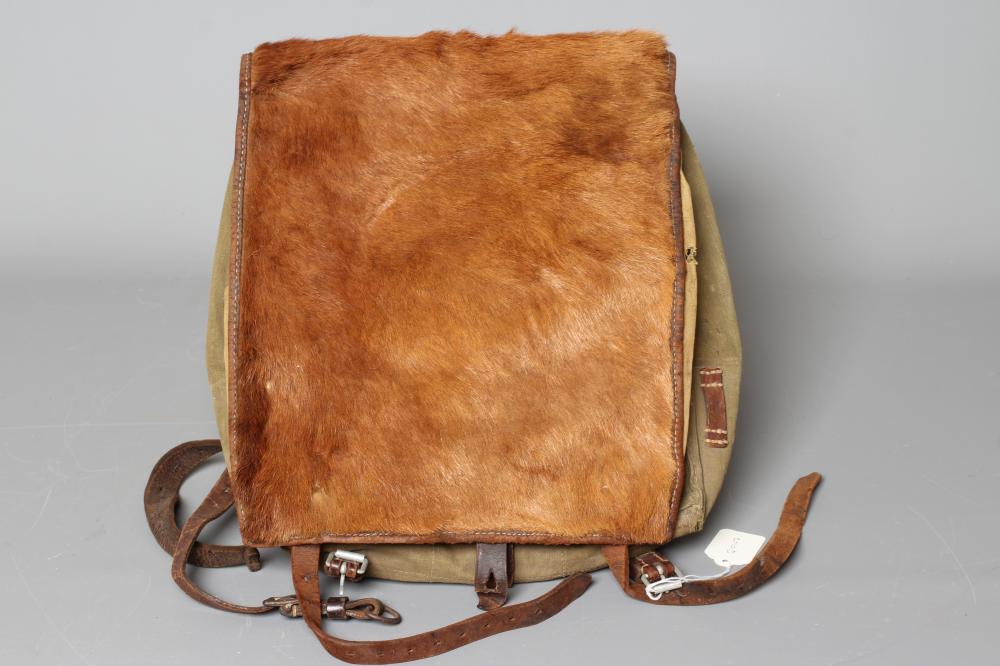 A GERMAN WWII TORNISTER BACKPACK, the canvas body with leather strapping, stamped "Heinrich Sattel, Image