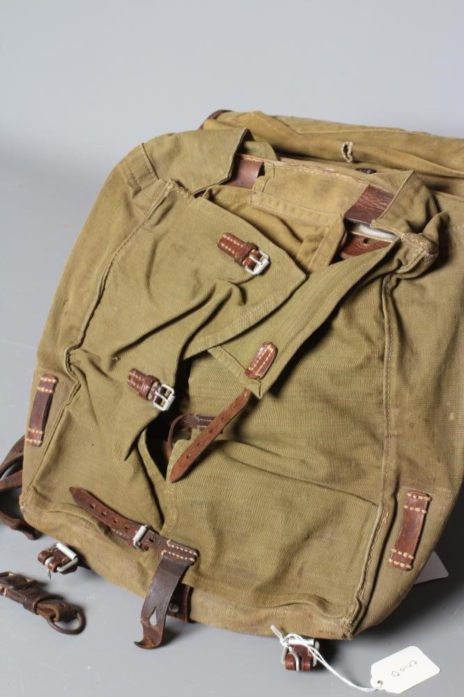 A GERMAN WWII TORNISTER BACKPACK, the canvas body with leather strapping, stamped "Heinrich Sattel, Image