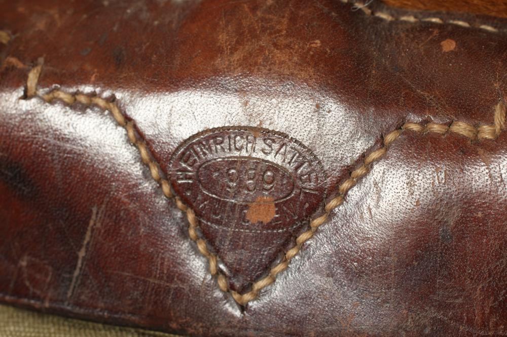 A GERMAN WWII TORNISTER BACKPACK, the canvas body with leather strapping, stamped "Heinrich Sattel, Image