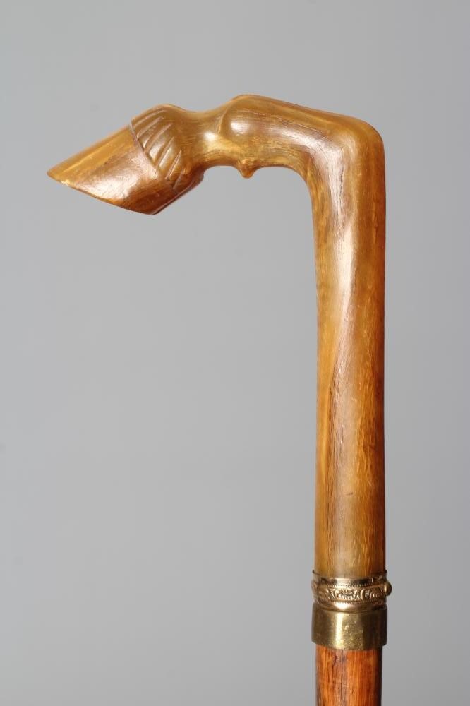 A LATE VICTORIAN SWORD STICK with a button released 26" flat section blade, horn grip carved as a Image