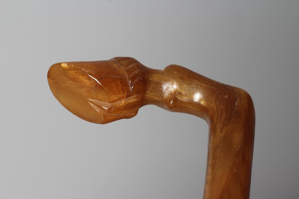 A LATE VICTORIAN SWORD STICK with a button released 26" flat section blade, horn grip carved as a Image