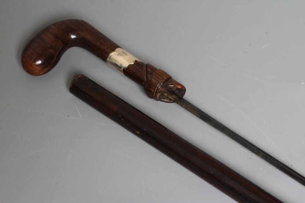 A SILVER MOUNTED SWORD STICK, Chester 1922, with 24 1/2" blued blade and buckle carved wood grip, 36 Image