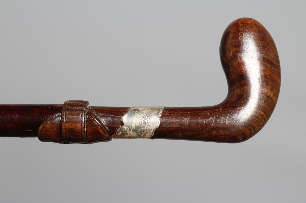 A SILVER MOUNTED SWORD STICK, Chester 1922, with 24 1/2" blued blade and buckle carved wood grip, 36 Image