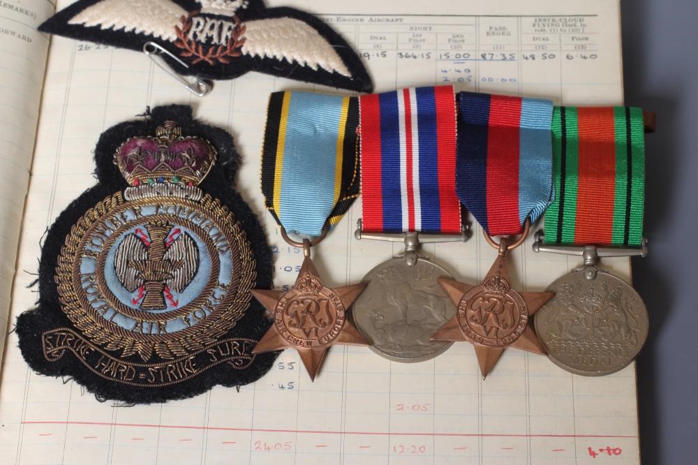 A FAMILY OF SECOND WORLD WAR MEDALS AND FLIGHT LOG BOOKS Image
