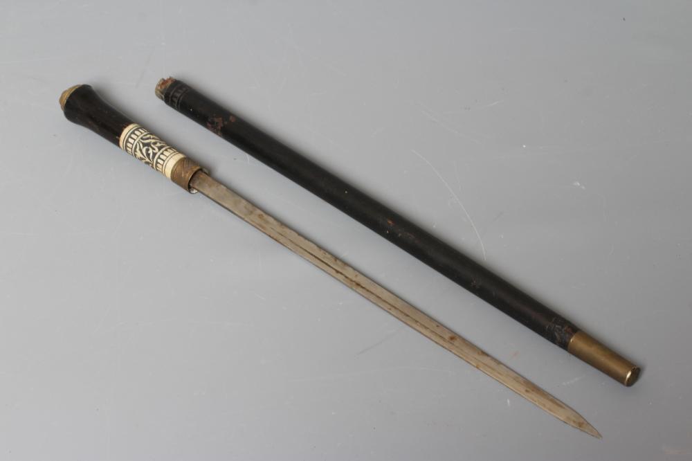 A SWAGGER SWORD STICK with 13 3/4" twist release ferrule, carved bone section to grip and lion Image
