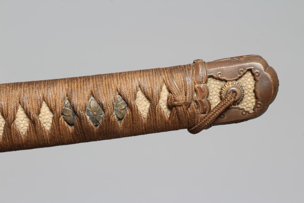 A JAPANESE KATANA with 24 1/2" curved blade, mildly undulating hamon, tang signed and painted, WWII Image