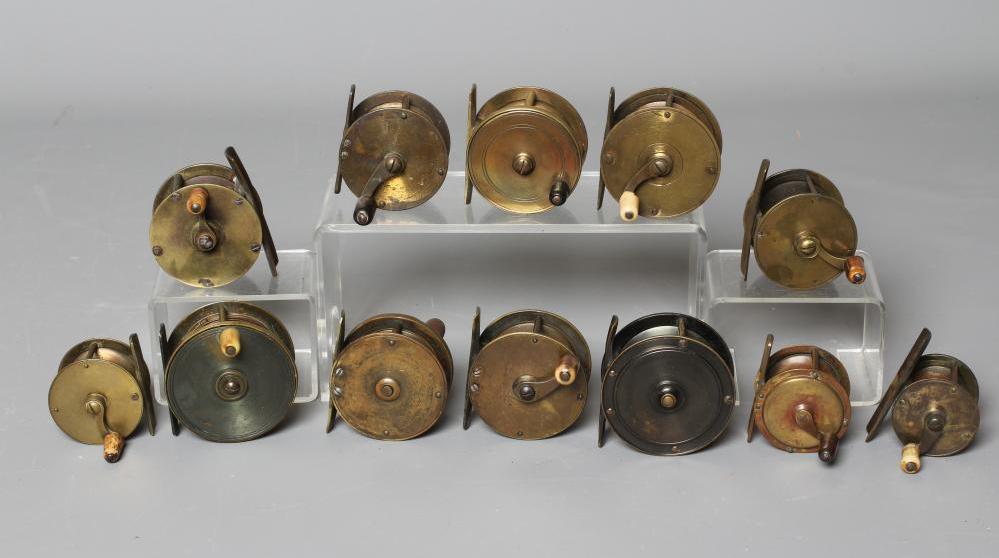TWELVE ANTIQUE BRASS FISHING REELS, the majority with bone and horn handles, largest 3" diameter Image