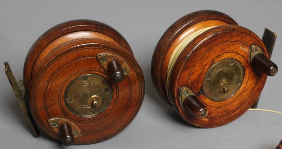 A MUSTAD & SON SEA HOOKS ADVERTISING BOARD, together with two antique star back reels and two gaffs Image