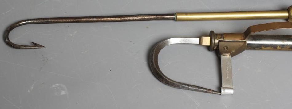 A MUSTAD & SON SEA HOOKS ADVERTISING BOARD, together with two antique star back reels and two gaffs Image