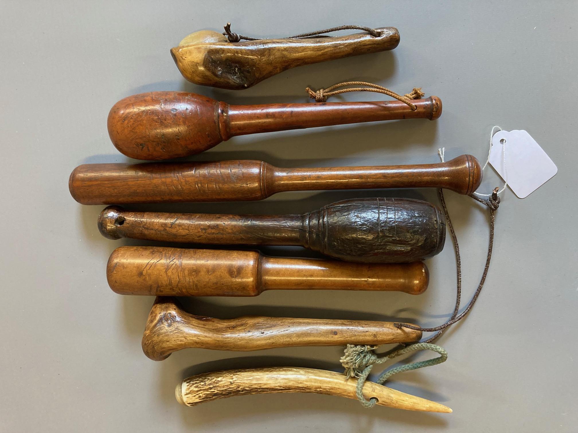 SEVEN ANTIQUE FISHING PRIESTS, four of turned hardwood construction, one root wood with inset Image