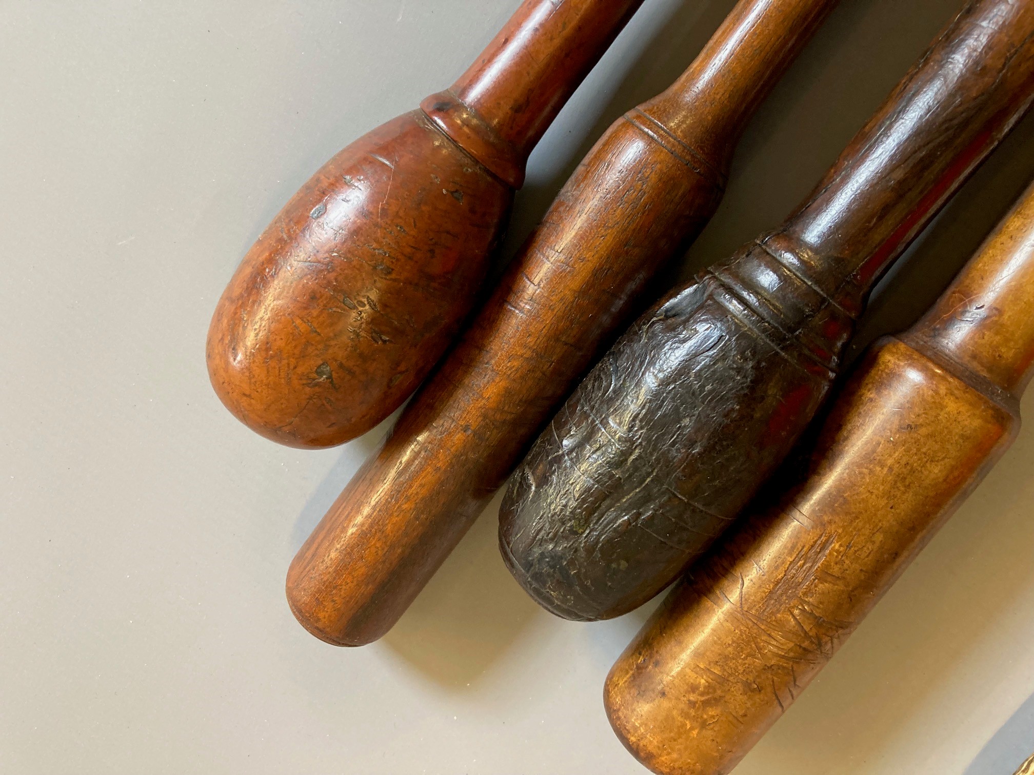 SEVEN ANTIQUE FISHING PRIESTS, four of turned hardwood construction, one root wood with inset Image