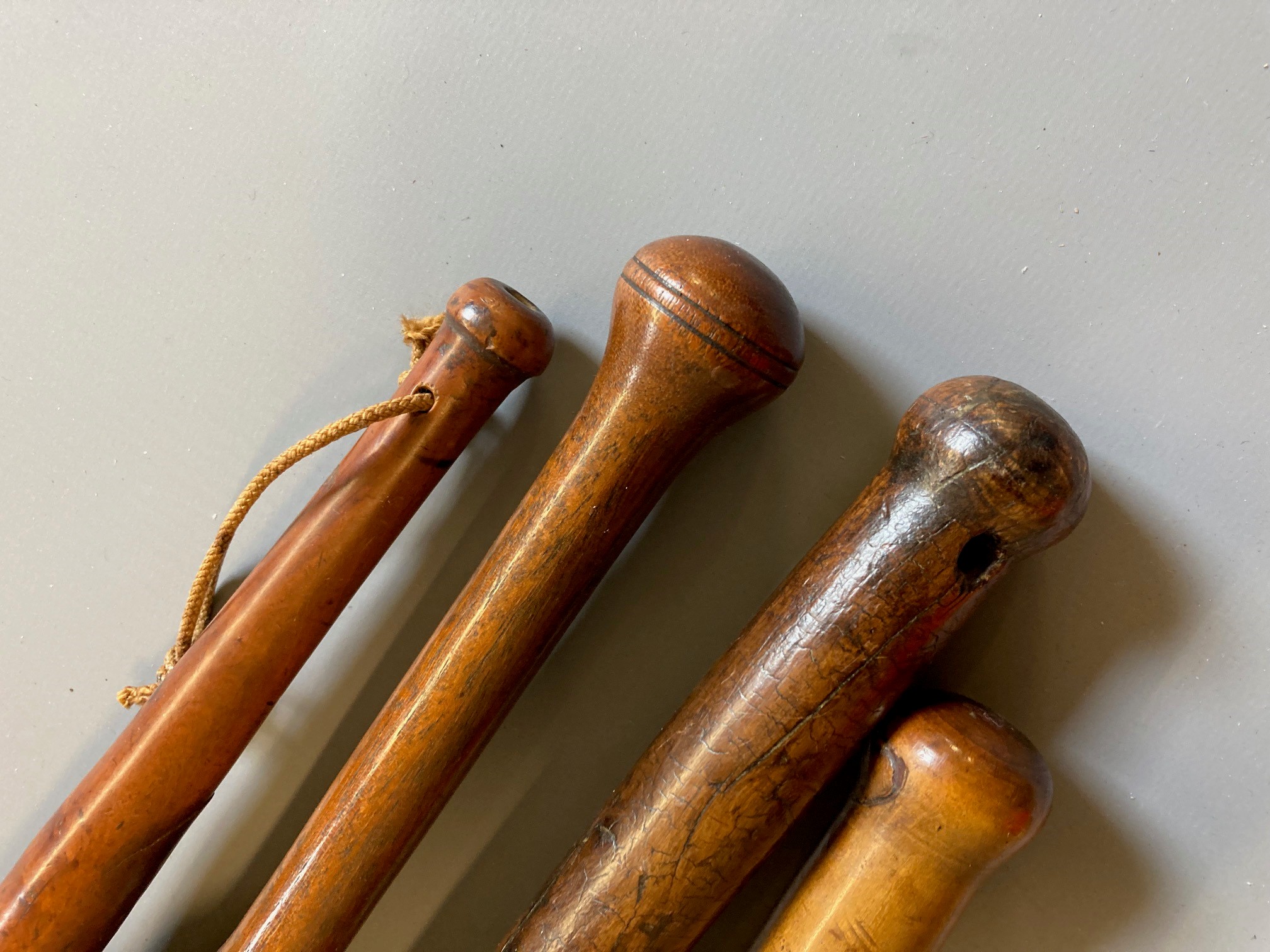 SEVEN ANTIQUE FISHING PRIESTS, four of turned hardwood construction, one root wood with inset Image