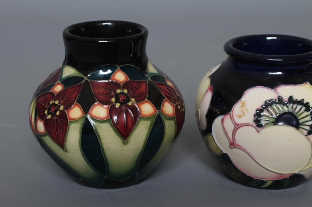THREE MOORCROFT POTTERY SMALL VASES all of squat globular form and comprising Cherry Blossom Image