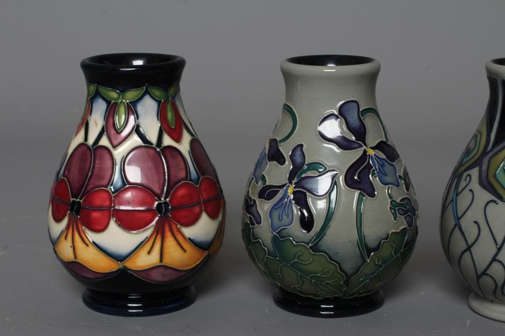 FOUR MOORCROFT POTTERY VASES all of baluster form and comprising Violetta Image