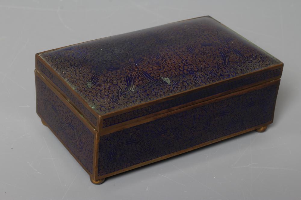 A CHINESE CLOISONNE ENAMEL CIGARETTE BOX of plain oblong form raised upon four ball feet Image