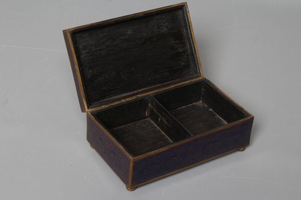 A CHINESE CLOISONNE ENAMEL CIGARETTE BOX of plain oblong form raised upon four ball feet Image