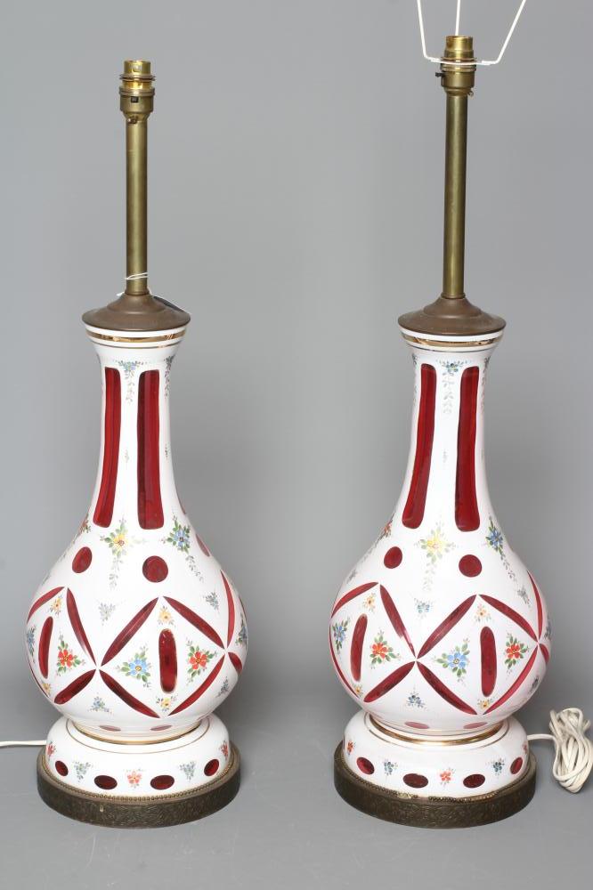 A PAIR OF WHITE OPAQUE OVERLAY CRANBERRY GLASS ELECTRIC TABLE LAMPS Image