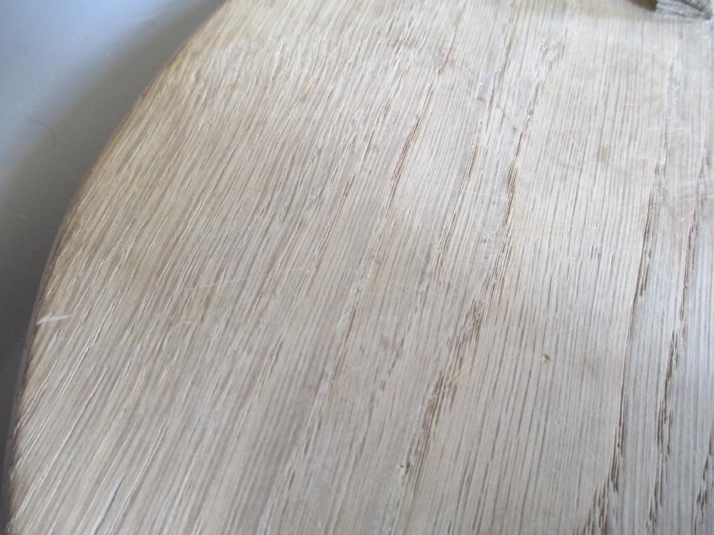 A ROBERT THOMPSON OAK CHEESEBOARD of oval form with carved mouse trademark in high relief, 14 1/2" Image