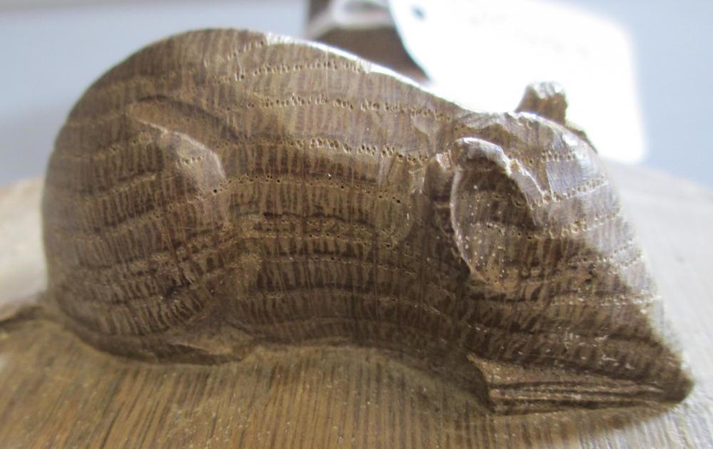 A ROBERT THOMPSON OAK CHEESEBOARD of oval form with carved mouse trademark in high relief, 14 1/2" Image