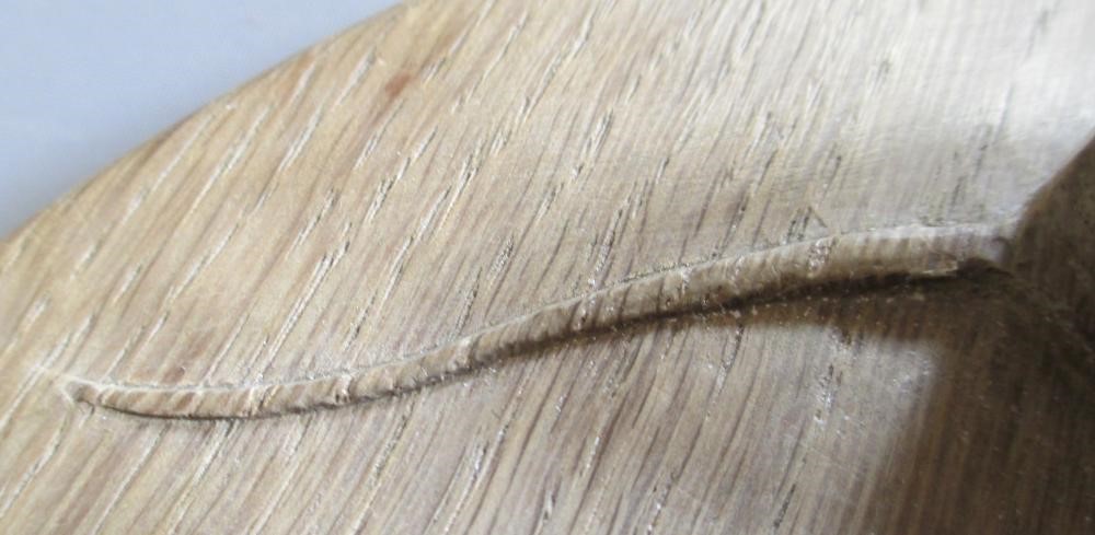 A ROBERT THOMPSON OAK CHEESEBOARD of oval form with carved mouse trademark in high relief, 14 1/2" Image