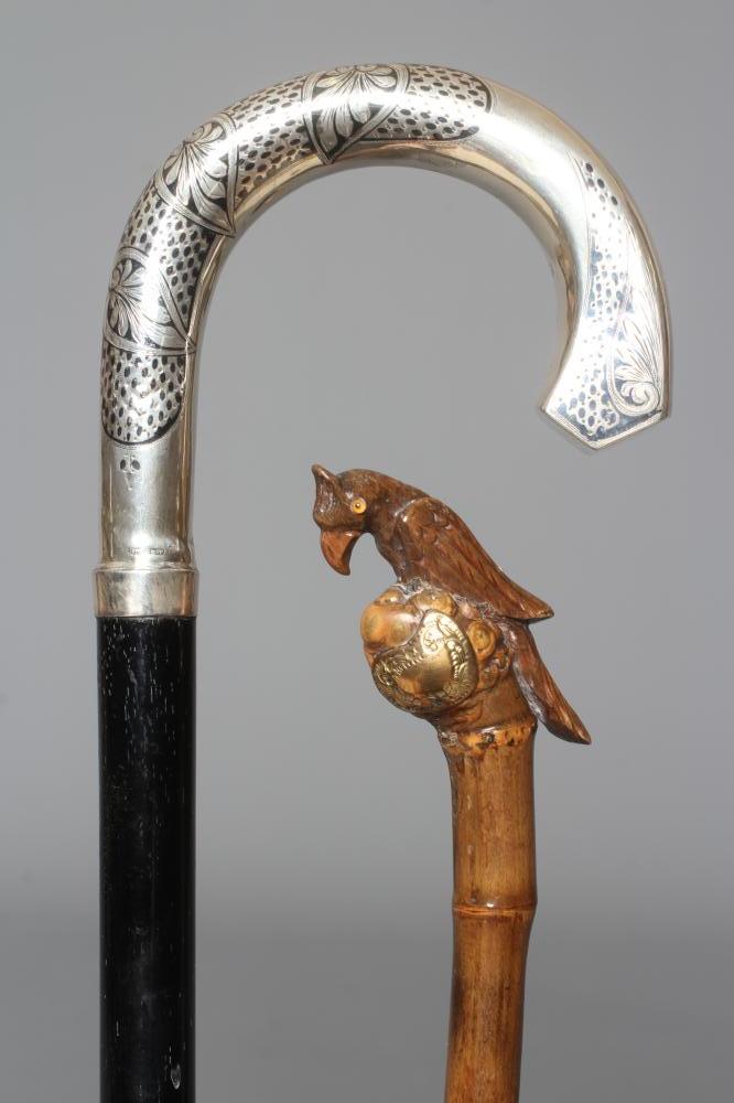 A 15CT GOLD MOUNTED BAMBOO STYLE WALKING CANE with exotic bird handle Image