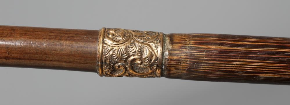A 15CT GOLD MOUNTED BAMBOO STYLE WALKING CANE with exotic bird handle Image