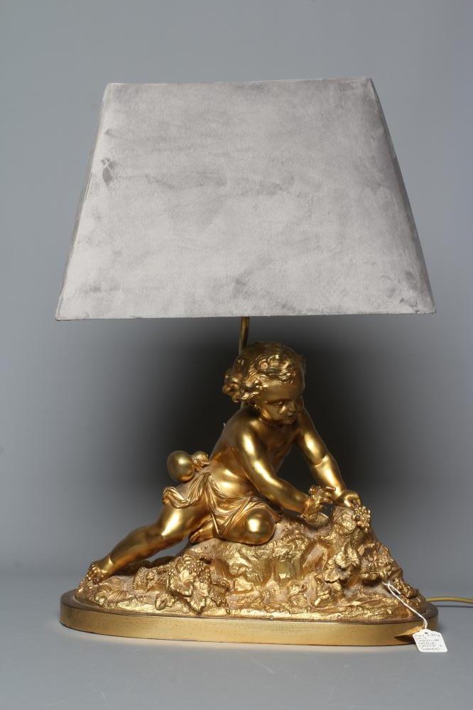 A GILT METAL AND COMPOSITION TABLE LAMP, 20th century, modelled as a cherub on a rocky outcrop Image