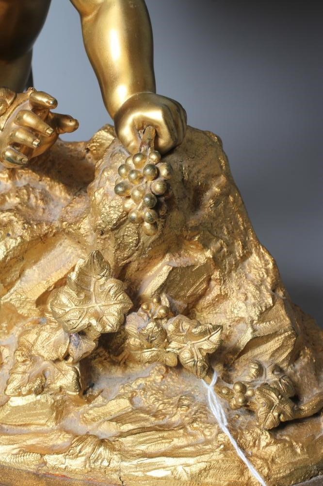 A GILT METAL AND COMPOSITION TABLE LAMP, 20th century, modelled as a cherub on a rocky outcrop Image