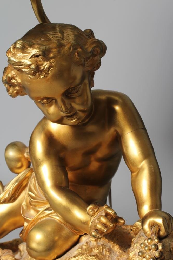 A GILT METAL AND COMPOSITION TABLE LAMP, 20th century, modelled as a cherub on a rocky outcrop Image