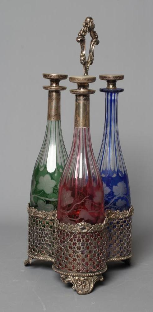 A SET OF THREE VICTORIAN COLOURED GLASS DECANTERS etched with fruiting vine Image