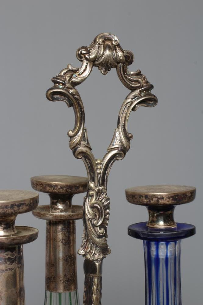 A SET OF THREE VICTORIAN COLOURED GLASS DECANTERS etched with fruiting vine Image