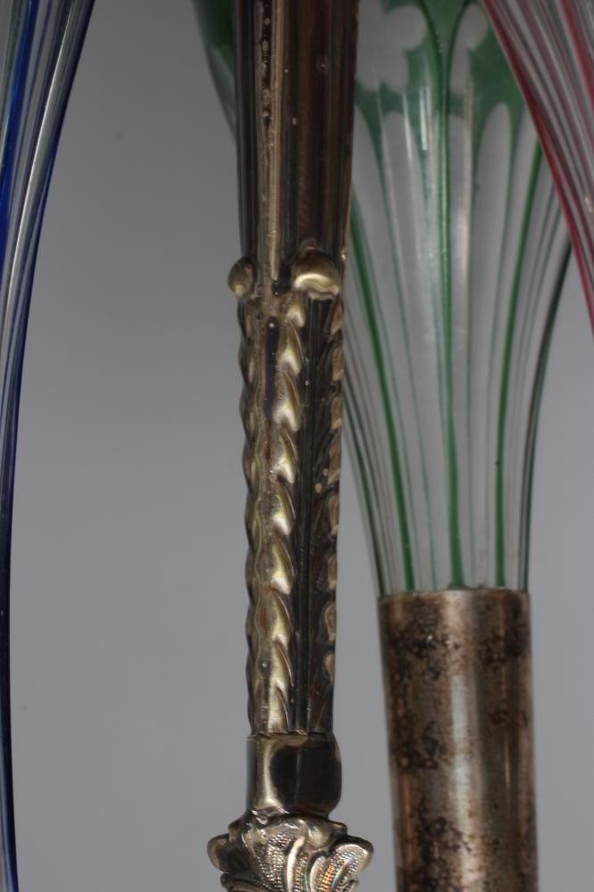 A SET OF THREE VICTORIAN COLOURED GLASS DECANTERS etched with fruiting vine Image