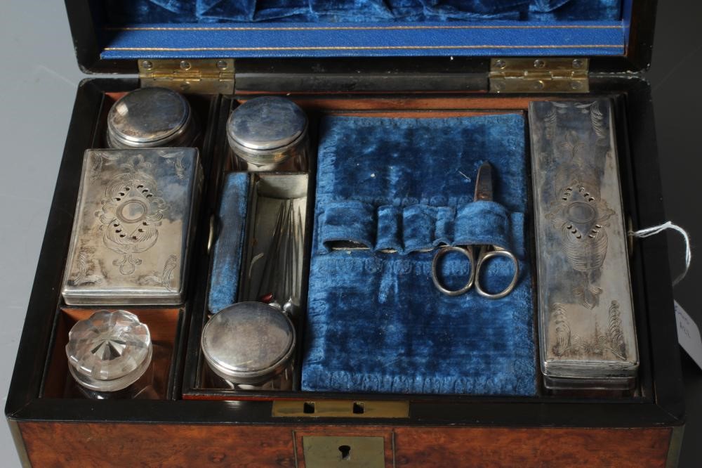 A VICTORIAN OBLONG BURR WALNUT AND BRASS BOUND TRAVELLING VANITY BOX with blue velvet lined fitted Image