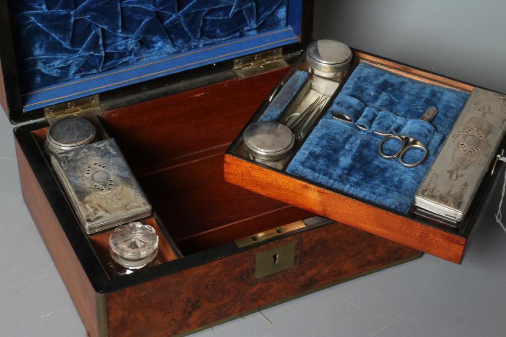 A VICTORIAN OBLONG BURR WALNUT AND BRASS BOUND TRAVELLING VANITY BOX with blue velvet lined fitted Image