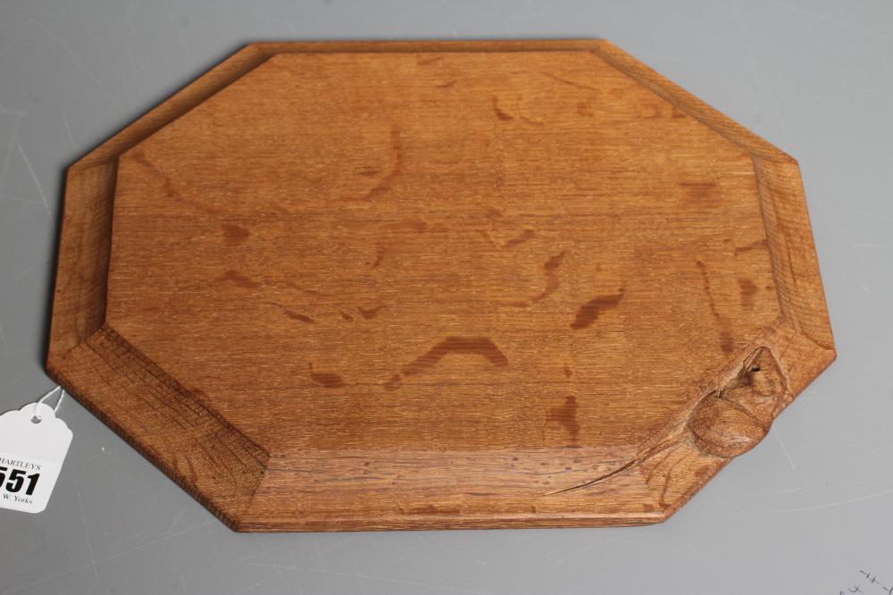 A ROBERT THOMPSON OAK CHEESE BOARD of oblong form with canted edges and mouse trademark carved in Image